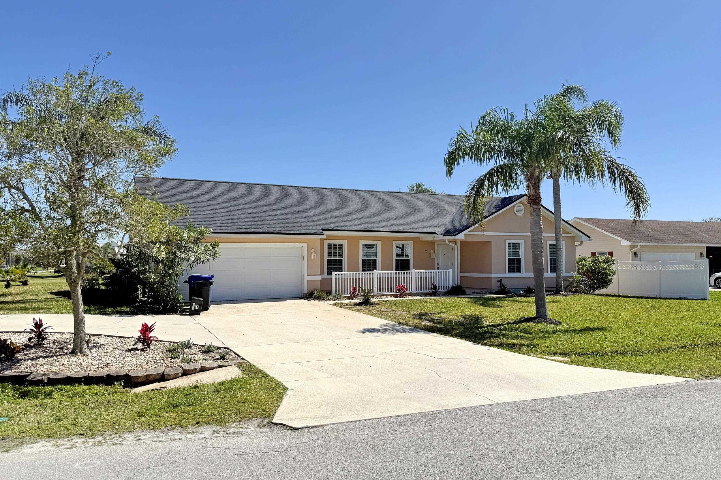 7 Hawaiian Boulevard St. Augustine, FL 32080 - Photo 1 of 19 a front view of a house with a yard and garage