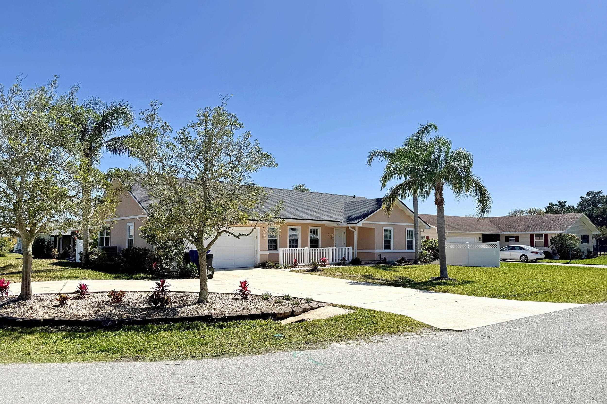 7 Hawaiian Boulevard St. Augustine, FL 32080 - Photo 2 of 19 a front view of a house with a yard and palm tree
