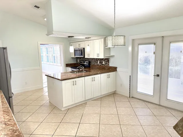 a kitchen with a stove a sink and a refrigerator