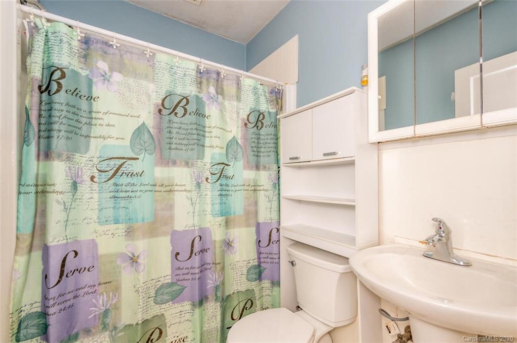 816 Allen Farm Road Canton, NC 28716 - Photo 14 of 25 a bathroom with a sink vanity mirror and toilet