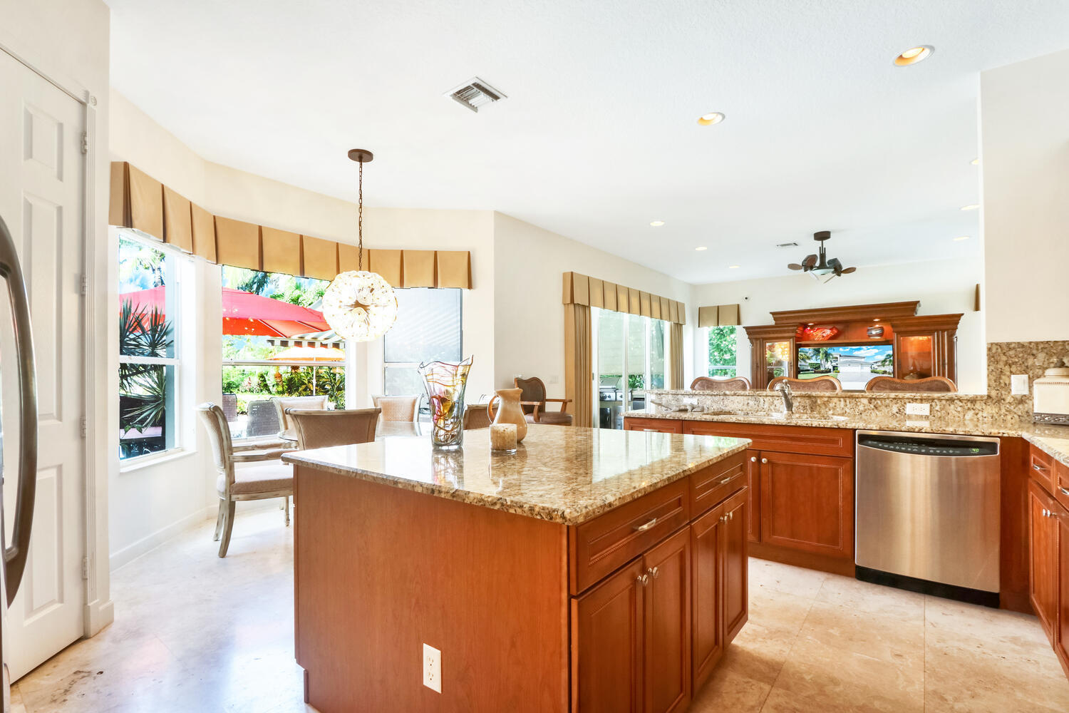 585 Southwest Yacht Basin Way Stuart, FL 34997 - Photo 11 of 31 a kitchen with stainless steel appliances granite countertop a stove and refrigerator
