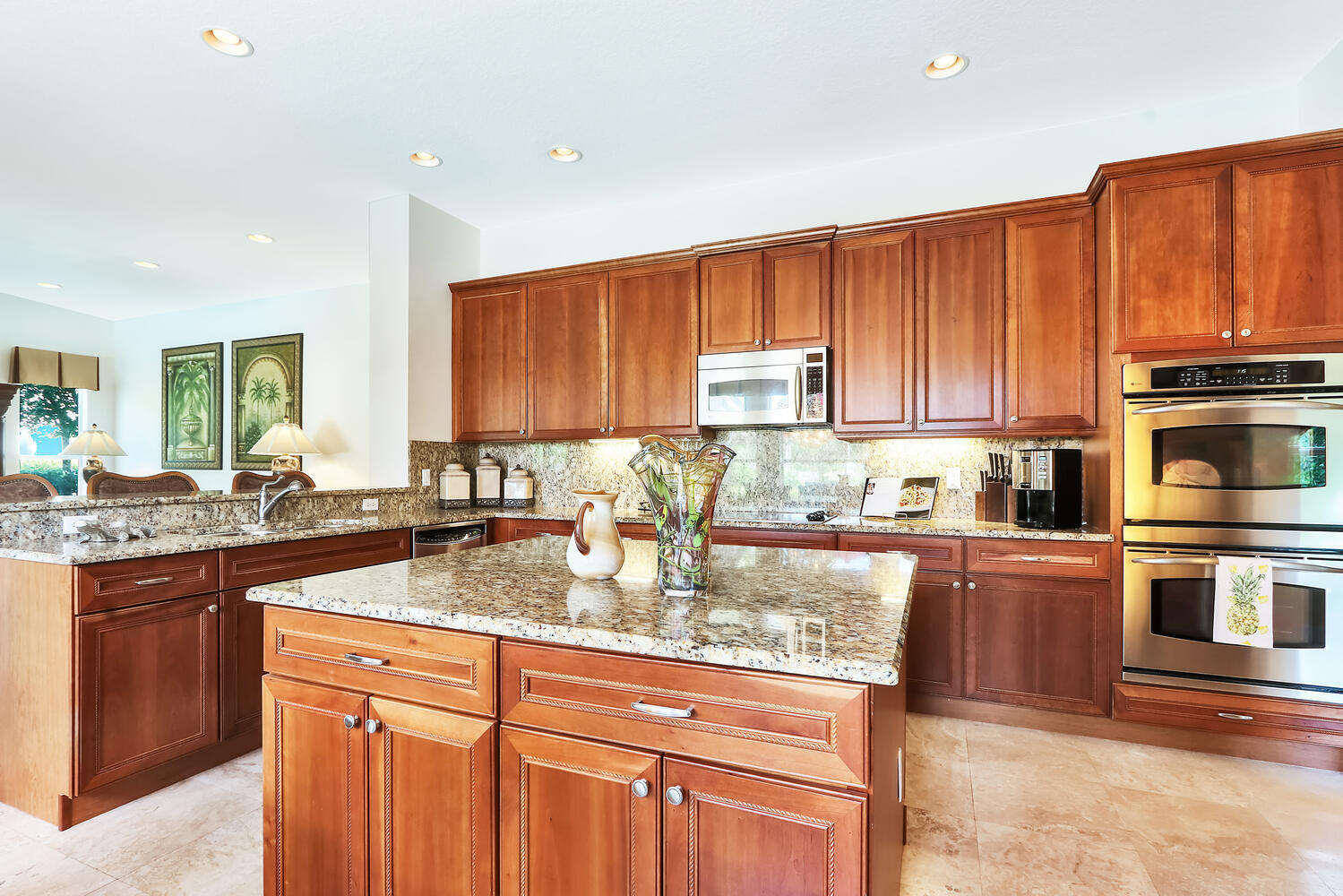 585 Southwest Yacht Basin Way Stuart, FL 34997 - Photo 12 of 31 a kitchen with stainless steel appliances granite countertop a stove top oven a sink dishwasher and cabinets with wooden floor