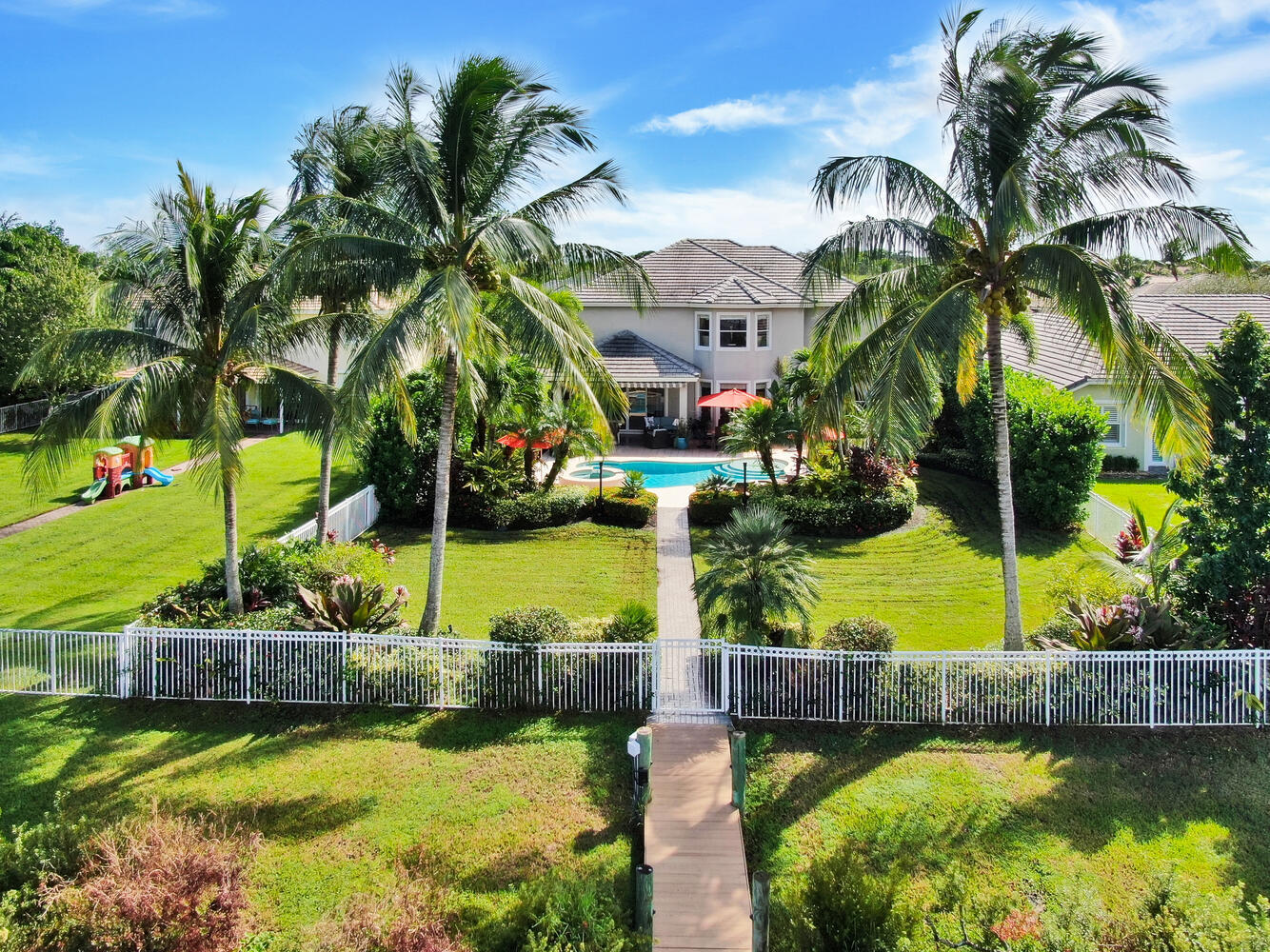 585 Southwest Yacht Basin Way Stuart, FL 34997 - Photo 28 of 31 a view of a house with swimming pool and lake view