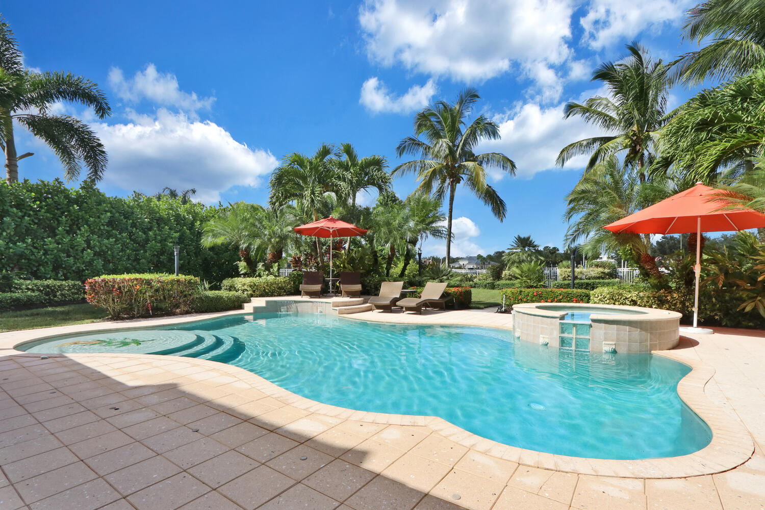 585 Southwest Yacht Basin Way Stuart, FL 34997 - Photo 7 of 31 a view of a swimming pool with a table and chairs under an umbrella
