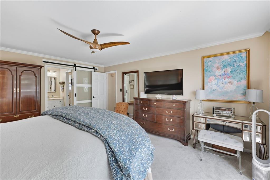 153 Dunlap Landing Road Gainesville, GA 30506 - Photo 28 of 67 a bedroom with furniture and a flat screen tv