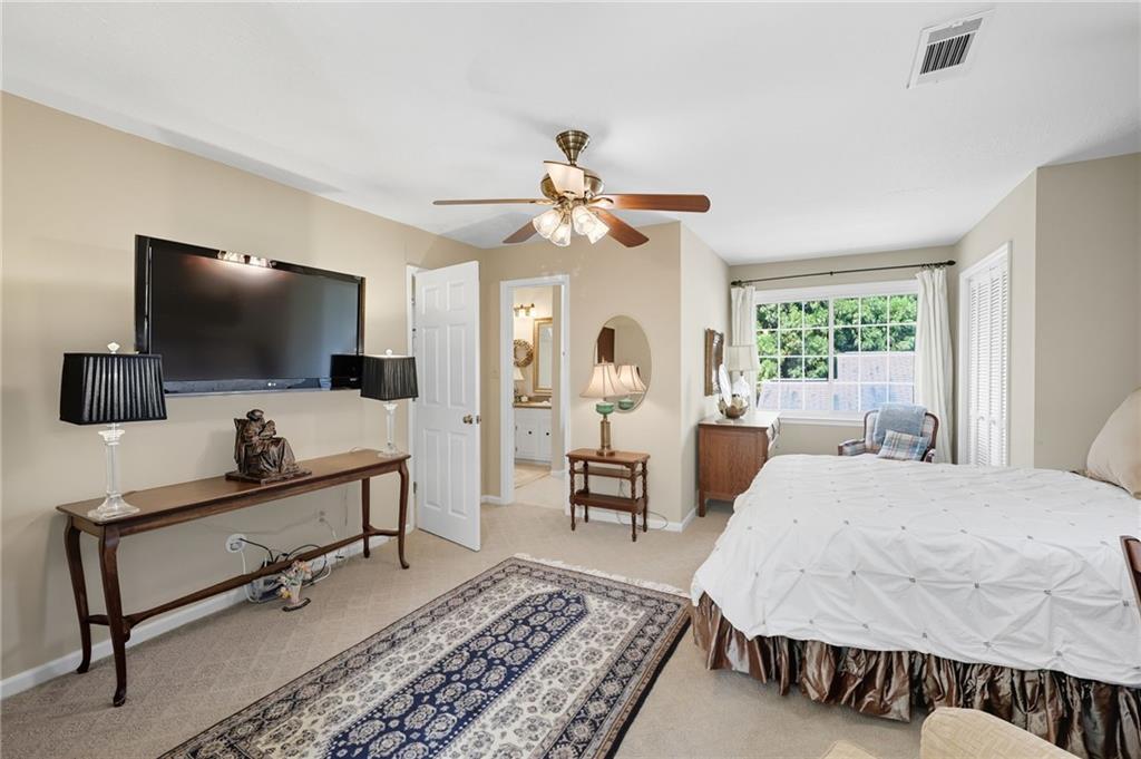 153 Dunlap Landing Road Gainesville, GA 30506 - Photo 32 of 67 a bedroom with a bed and a flat screen tv