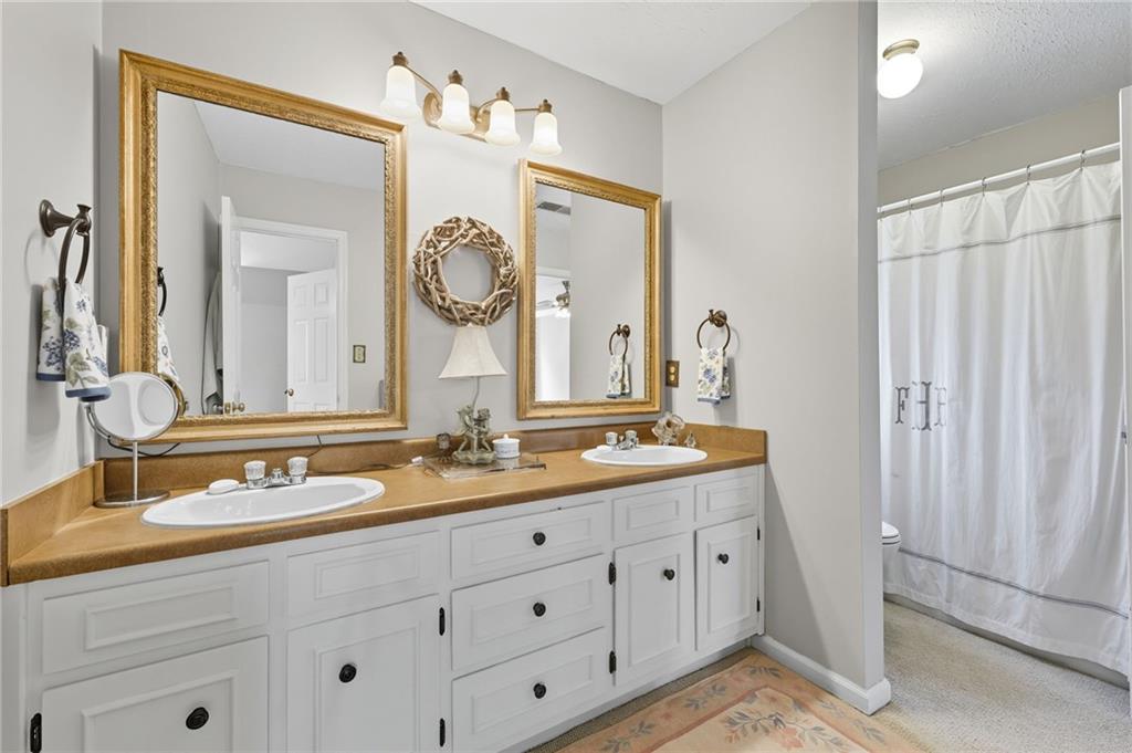 153 Dunlap Landing Road Gainesville, GA 30506 - Photo 33 of 67 a bathroom with a double vanity sink and a mirror