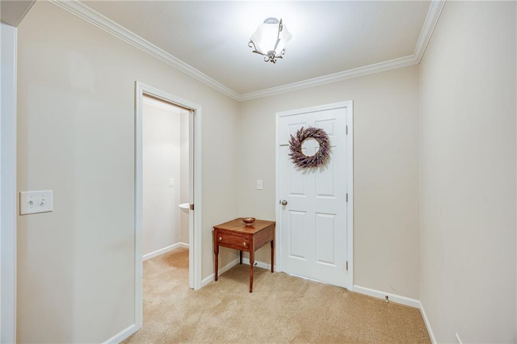 153 Dunlap Landing Road Gainesville, GA 30506 - Photo 58 of 67 a hallway with couches and a bookshelf with wooden floor