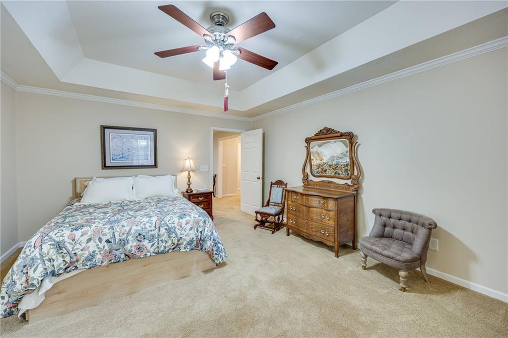 153 Dunlap Landing Road Gainesville, GA 30506 - Photo 61 of 67 a bedroom with a bed and a chandelier