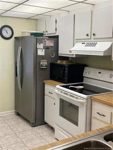 a living room with furniture and a lamp