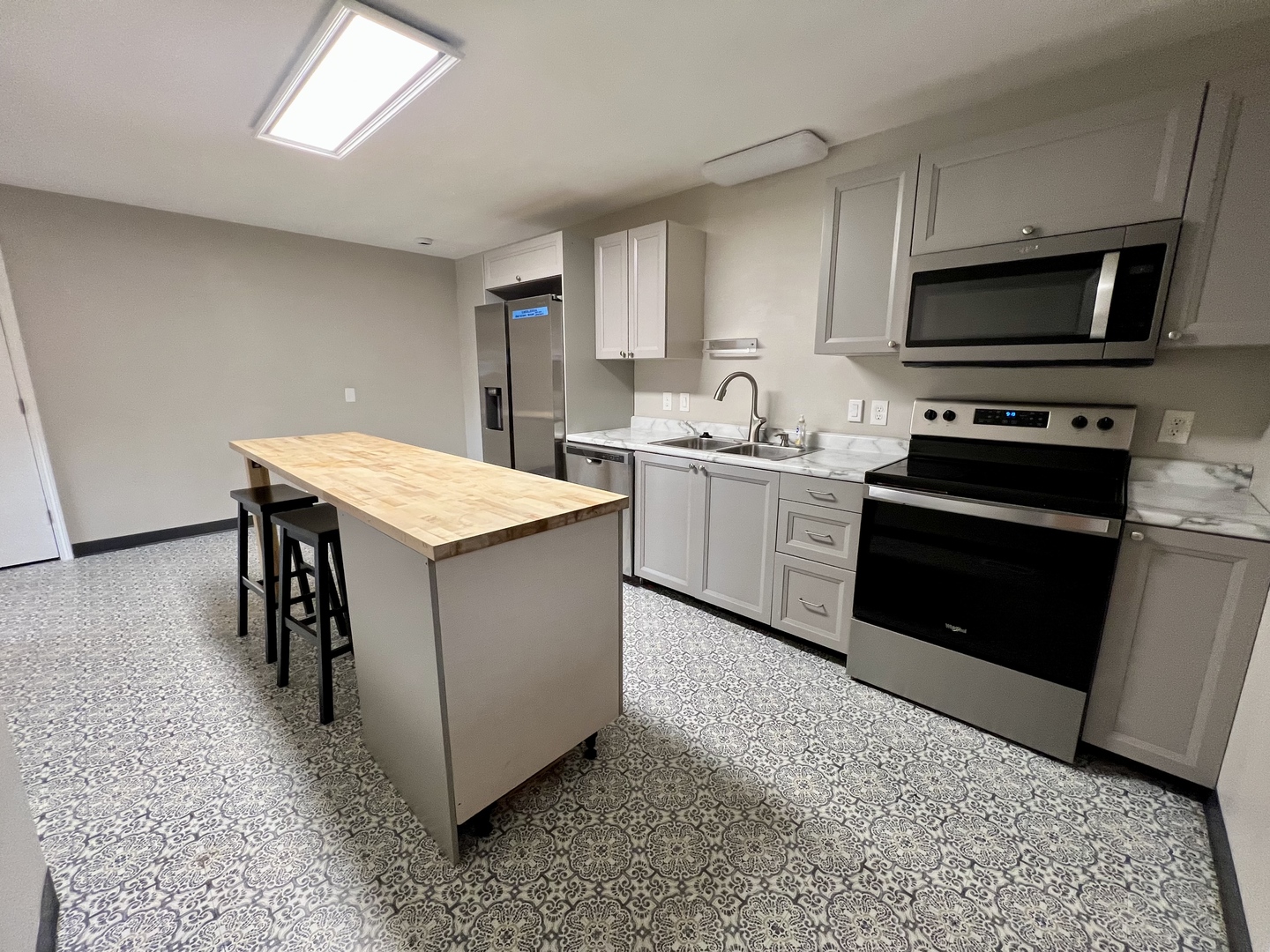 1528 Division Street Charleston, IL 61920 - Photo 13 of 45 a kitchen with stainless steel appliances granite countertop a stove a sink and a microwave