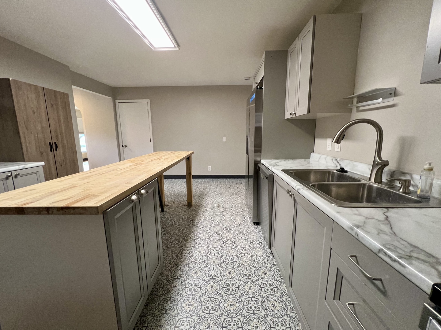 1528 Division Street Charleston, IL 61920 - Photo 15 of 45 a kitchen with stainless steel appliances a sink a stove top oven a counter space and cabinets