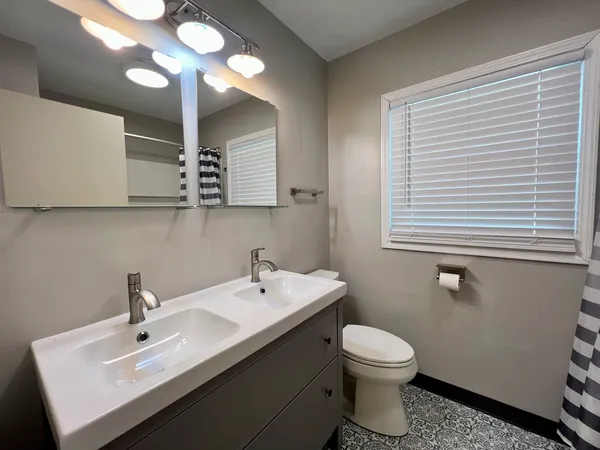 a bathroom with a toilet sink and mirror