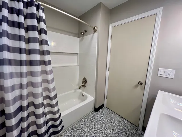 a bathroom with a bathtub and a shower