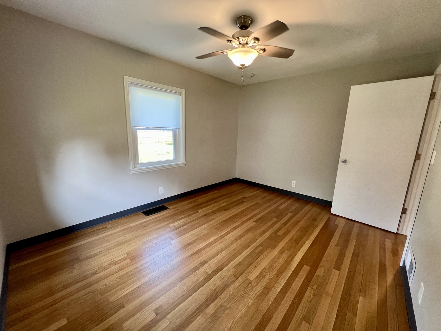 1528 Division Street Charleston, IL 61920 - Photo 24 of 45 a view of an empty room with wooden floor and a window