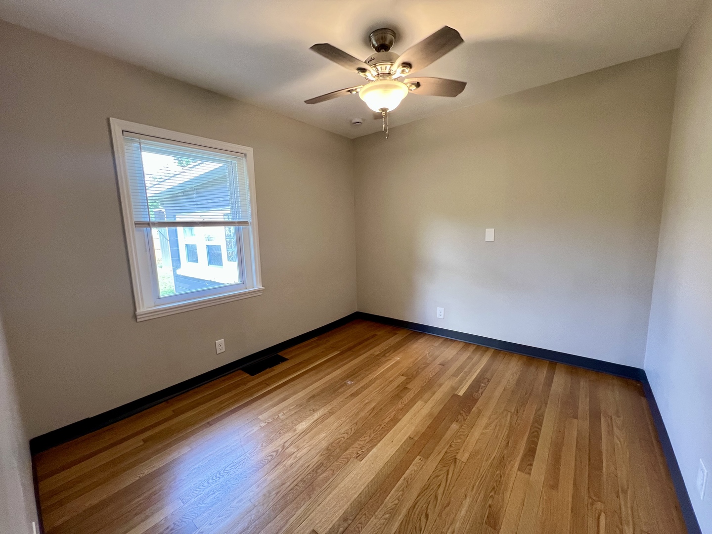 1528 Division Street Charleston, IL 61920 - Photo 27 of 45 a view of an empty room with a window and wooden floor