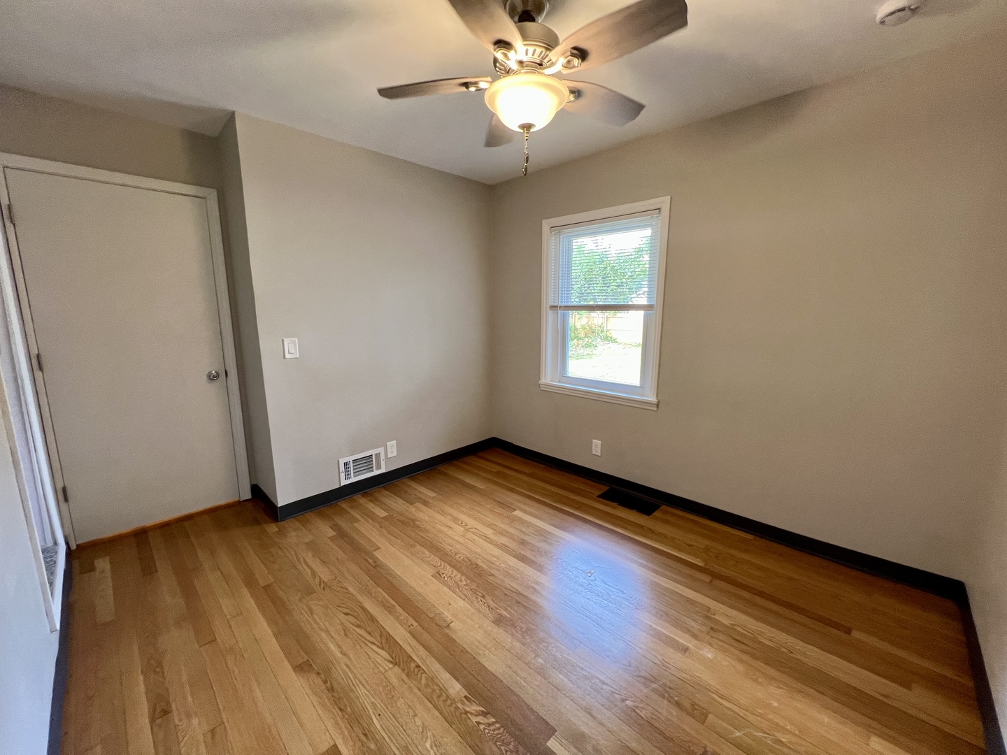 1528 Division Street Charleston, IL 61920 - Photo 30 of 45 a view of an empty room with wooden floor and a window