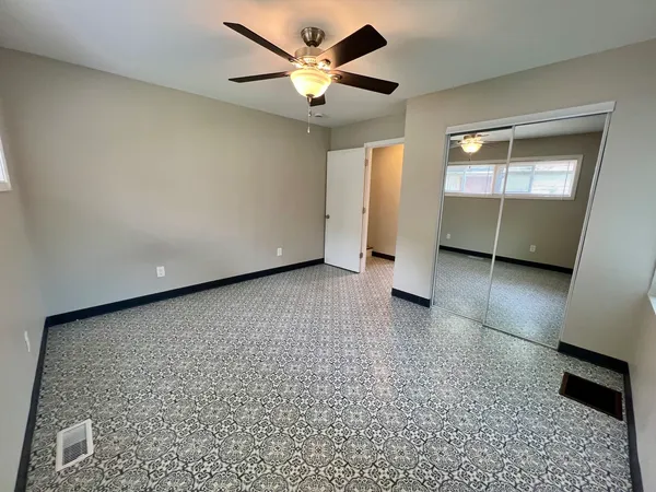 a view of a livingroom with a ceiling fan and window
