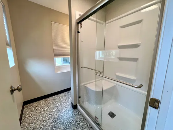 a bathroom with a bathtub and a shower