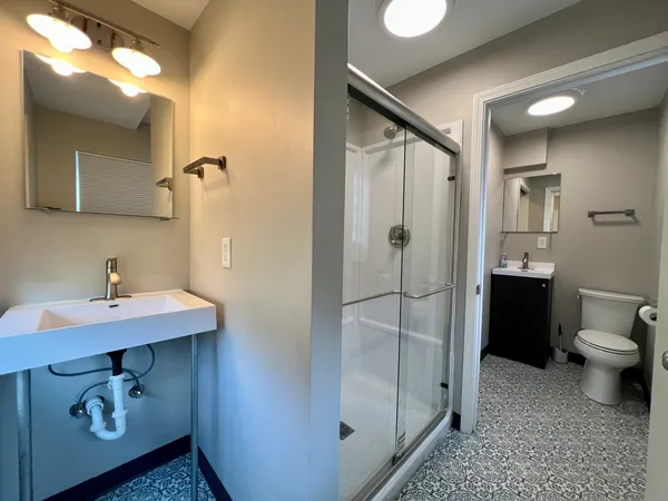 a bathroom with a sink toilet and shower