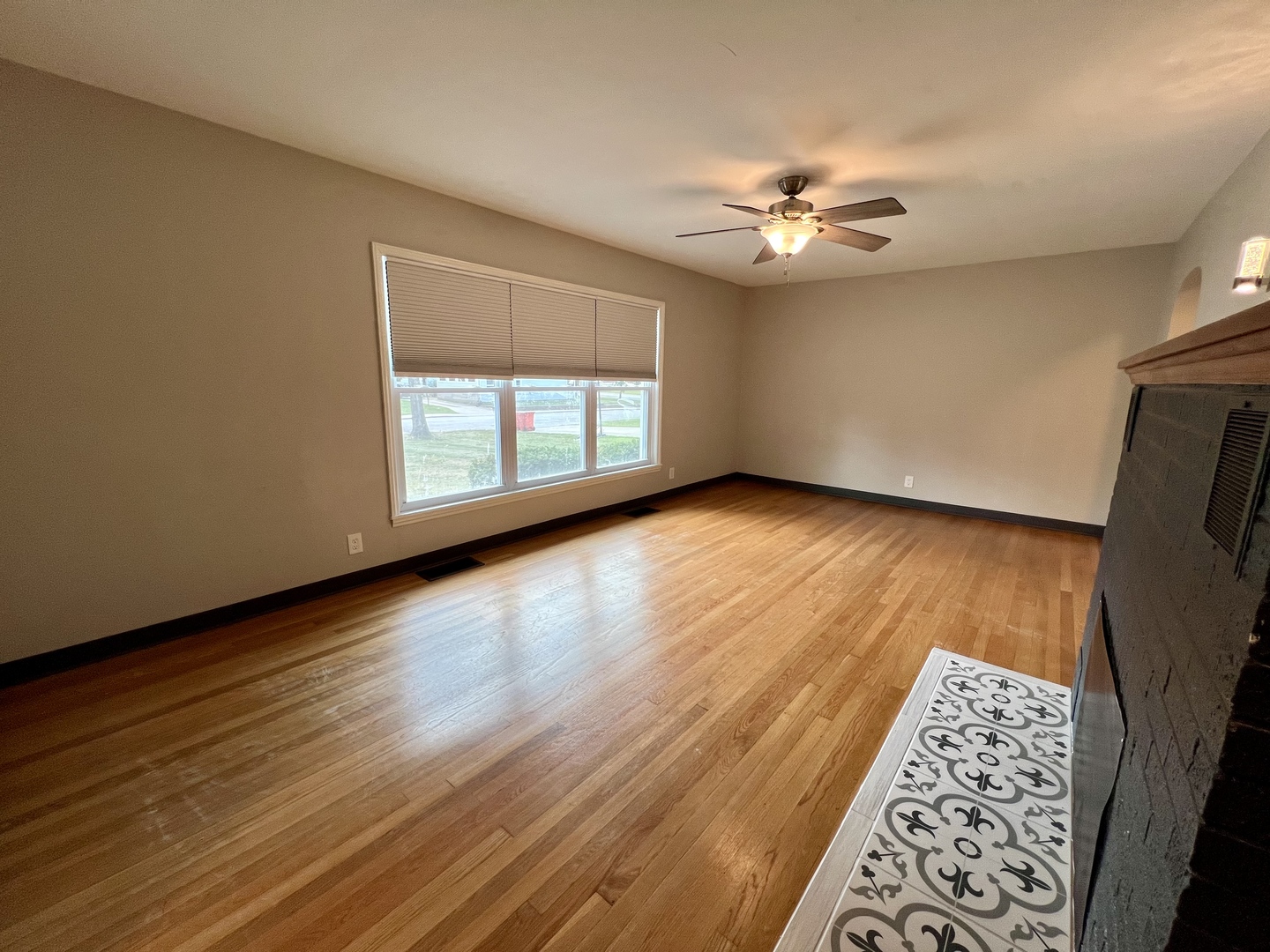 1528 Division Street Charleston, IL 61920 - Photo 4 of 45 a view of an empty room with window and wooden floor