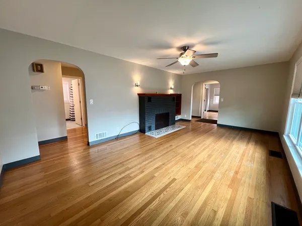 wooden floor in an empty room with a window
