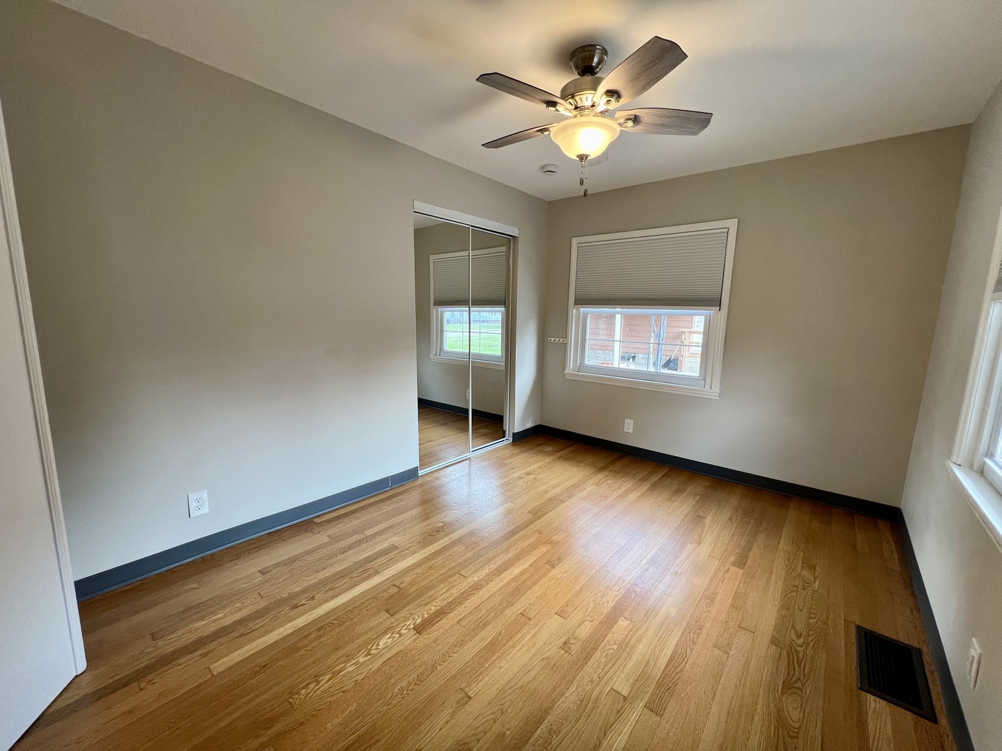 1528 Division Street Charleston, IL 61920 - Photo 7 of 45 a view of an empty room with wooden floor and a window
