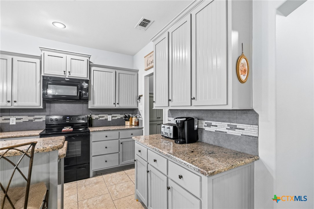 711 Mason Circle Victoria, TX 77904 - Photo 11 of 29 a kitchen with stainless steel appliances granite countertop a sink stove and cabinets
