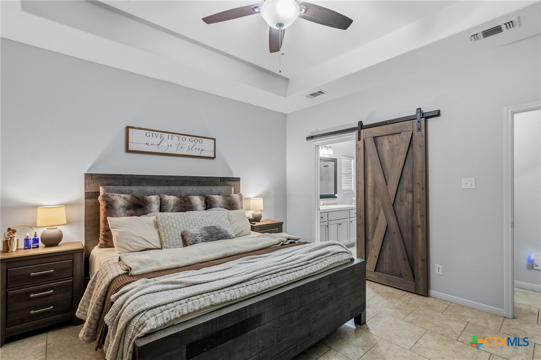 711 Mason Circle Victoria, TX 77904 - Photo 13 of 29 a bedroom with a bed and a chandelier