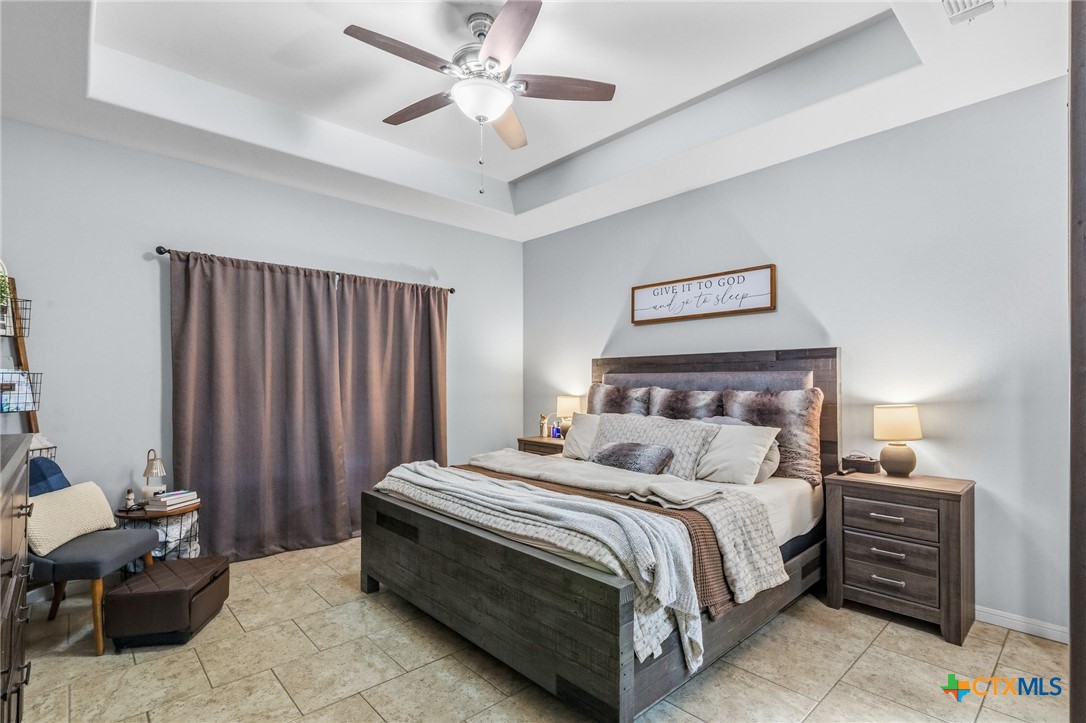 711 Mason Circle Victoria, TX 77904 - Photo 14 of 29 a bedroom with a bed and a chandelier