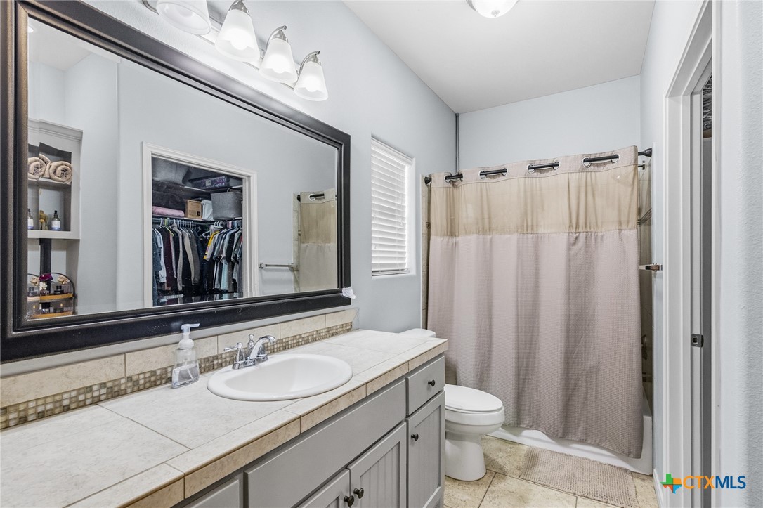 711 Mason Circle Victoria, TX 77904 - Photo 15 of 29 a bathroom with a double vanity sink toilet and shower