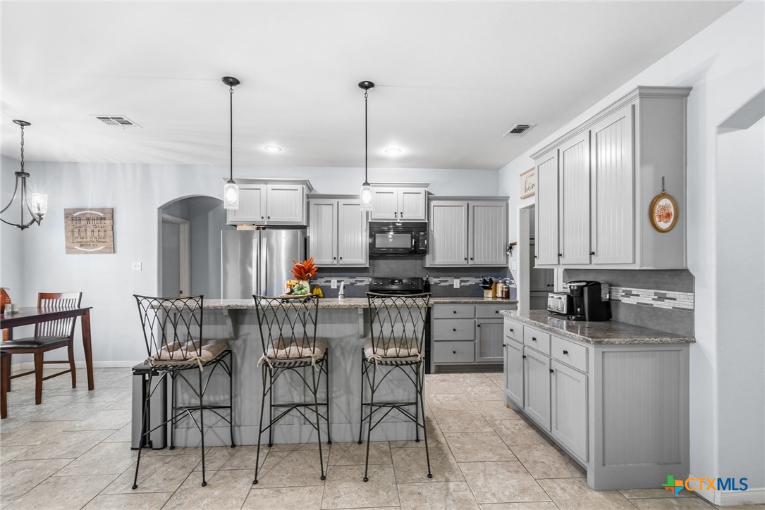 711 Mason Circle Victoria, TX 77904 - Photo 7 of 29 a kitchen with stainless steel appliances kitchen island granite countertop a sink and cabinets