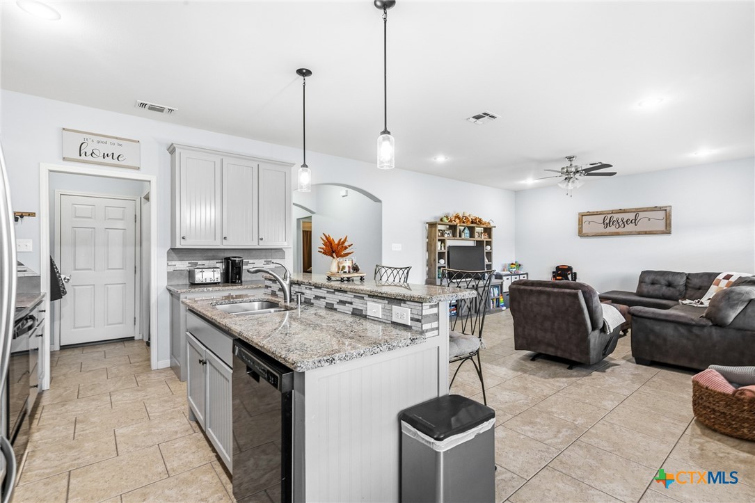711 Mason Circle Victoria, TX 77904 - Photo 9 of 29 a kitchen with stainless steel appliances granite countertop a sink a stove and a wooden floors