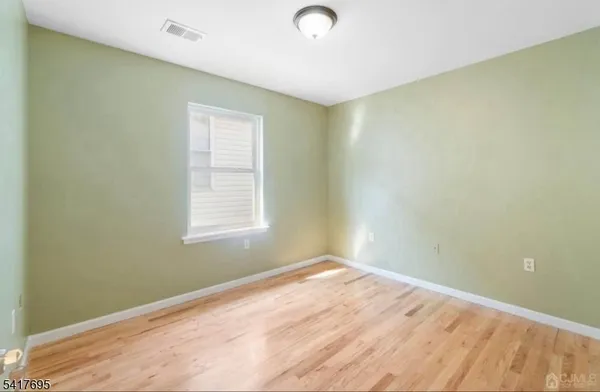 a view of a room with wooden floor and fan