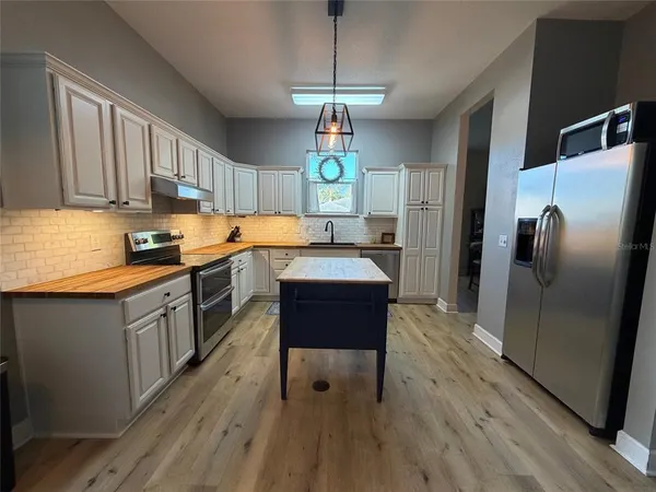 a kitchen with a sink cabinets and window