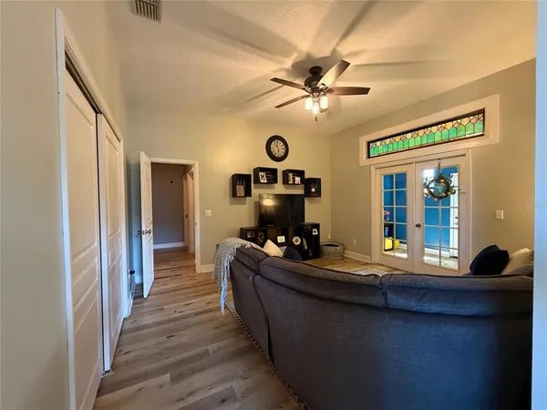 a living room with furniture and a wooden floor