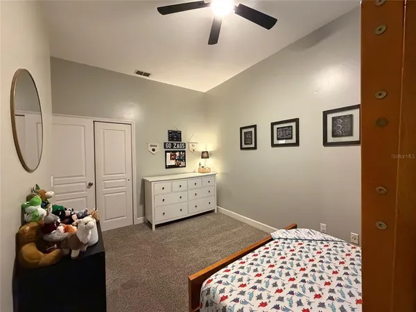 a bedroom with bed couch and window