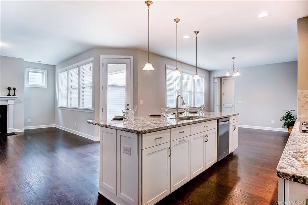 1280 Independence Street, Unit 58 Tega Cay, SC 29708 - Photo 11 of 31 a kitchen with sink stove and wooden floor