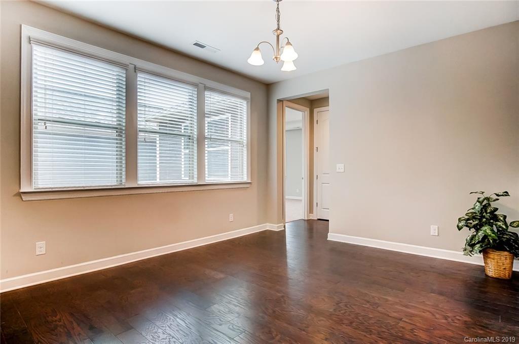 1280 Independence Street, Unit 58 Tega Cay, SC 29708 - Photo 12 of 31 a view of an empty room with wooden floor and a window