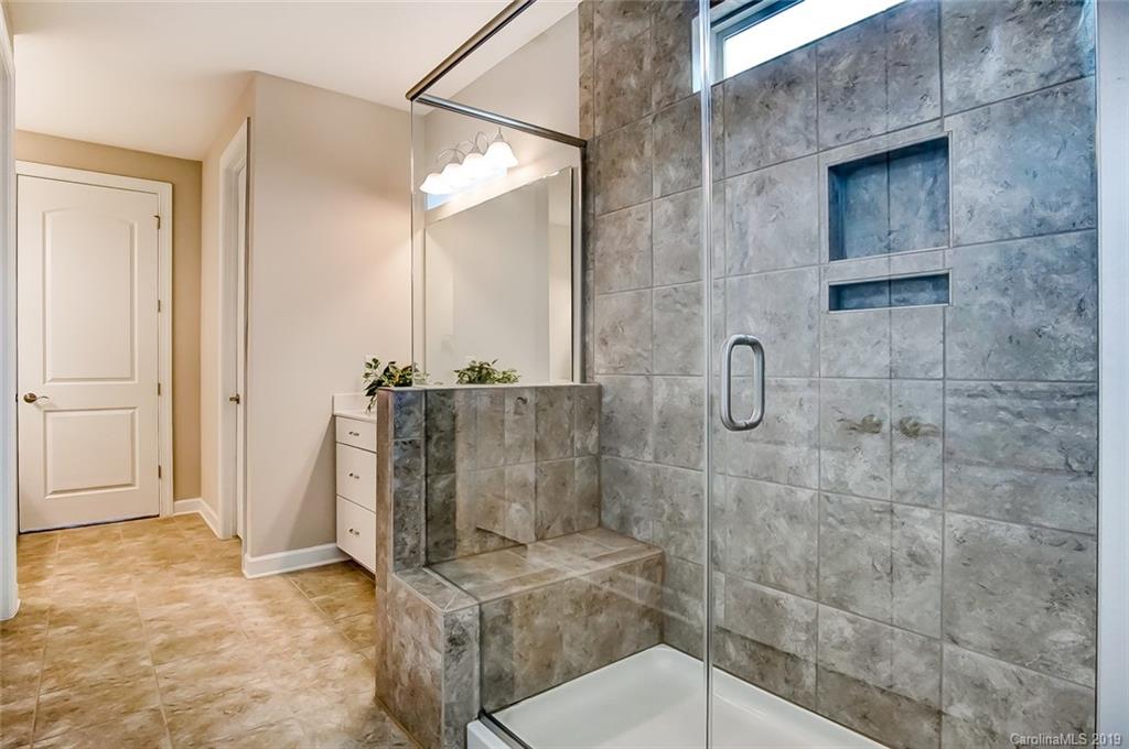 1280 Independence Street, Unit 58 Tega Cay, SC 29708 - Photo 19 of 31 a bathroom with a granite countertop shower