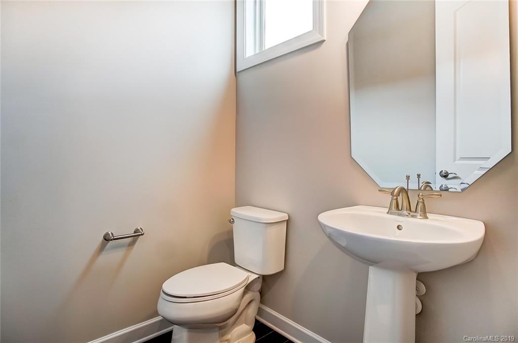 1280 Independence Street, Unit 58 Tega Cay, SC 29708 - Photo 24 of 31 a bathroom with a sink toilet and a mirror