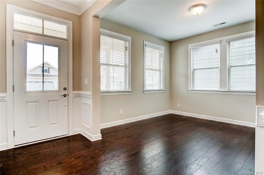 1280 Independence Street, Unit 58 Tega Cay, SC 29708 - Photo 4 of 31 an empty room with wooden floor and windows