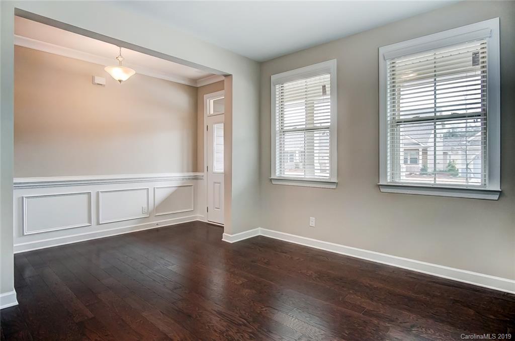 1280 Independence Street, Unit 58 Tega Cay, SC 29708 - Photo 5 of 31 an empty room with wooden floor and windows