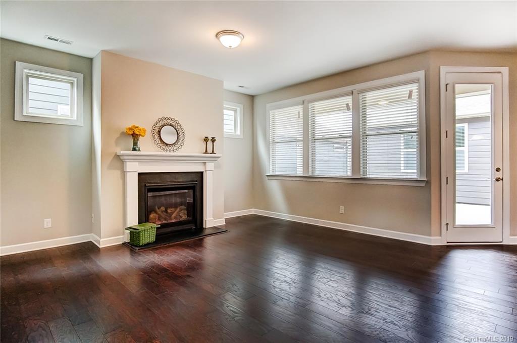 1280 Independence Street, Unit 58 Tega Cay, SC 29708 - Photo 6 of 31 an empty room with windows and fireplace
