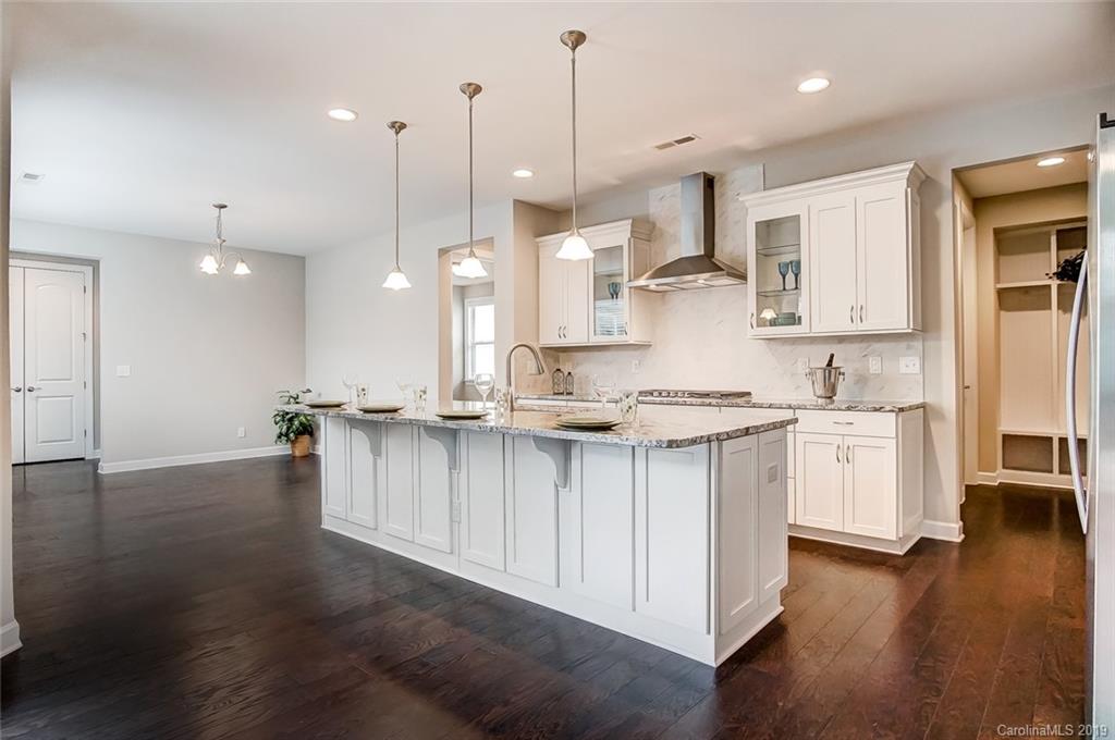 1280 Independence Street, Unit 58 Tega Cay, SC 29708 - Photo 8 of 31 a large kitchen with lots of counter space wooden floor and stainless steel appliances