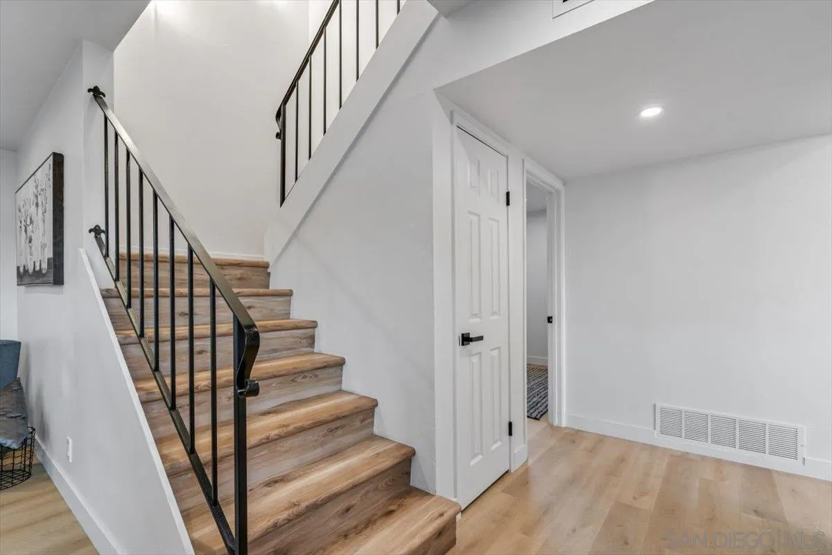 13259 Saddle Ridge Road Lakeside, CA 92040 - Photo 14 of 57 a view of staircase with wooden floor and white walls