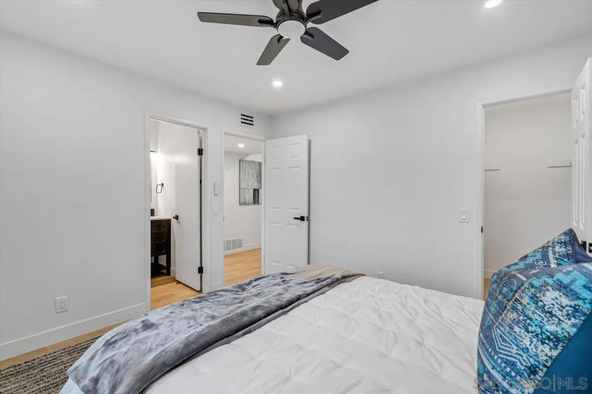 13259 Saddle Ridge Road Lakeside, CA 92040 - Photo 26 of 57 a bedroom with a bed and a chandelier