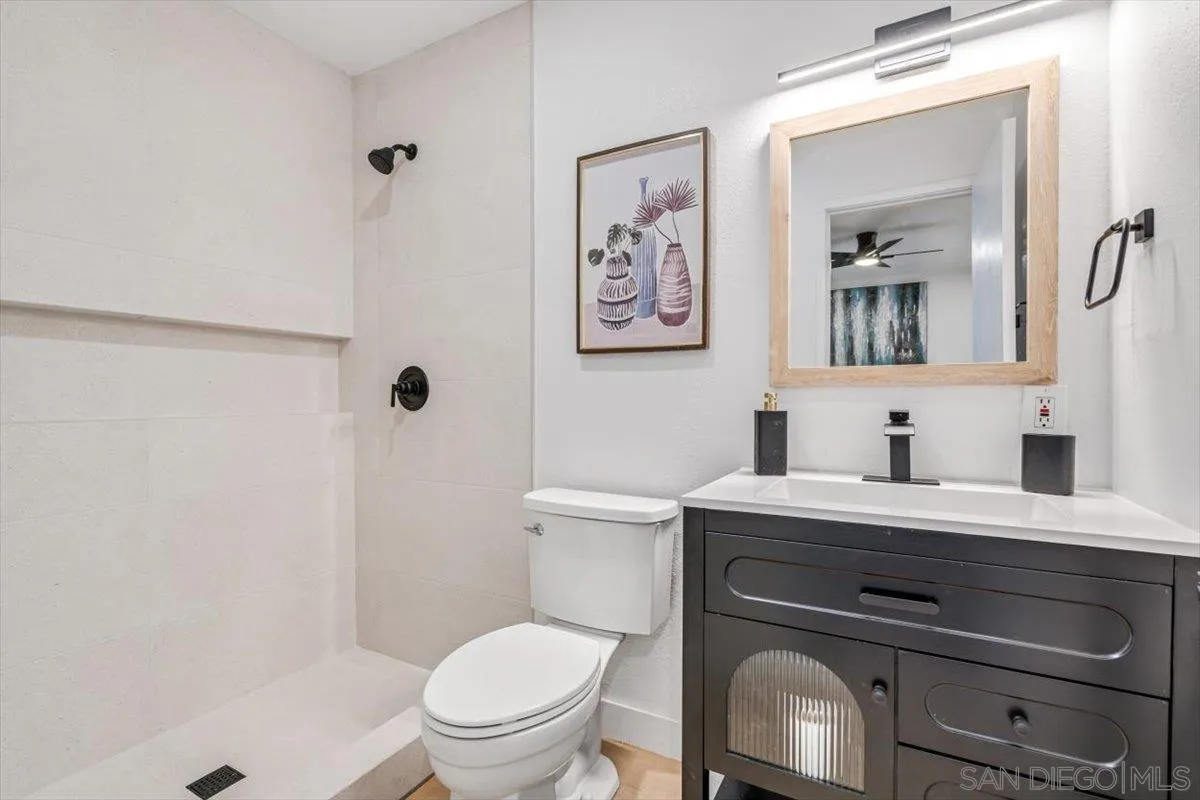 13259 Saddle Ridge Road Lakeside, CA 92040 - Photo 29 of 57 a bathroom with a toilet a sink and mirror