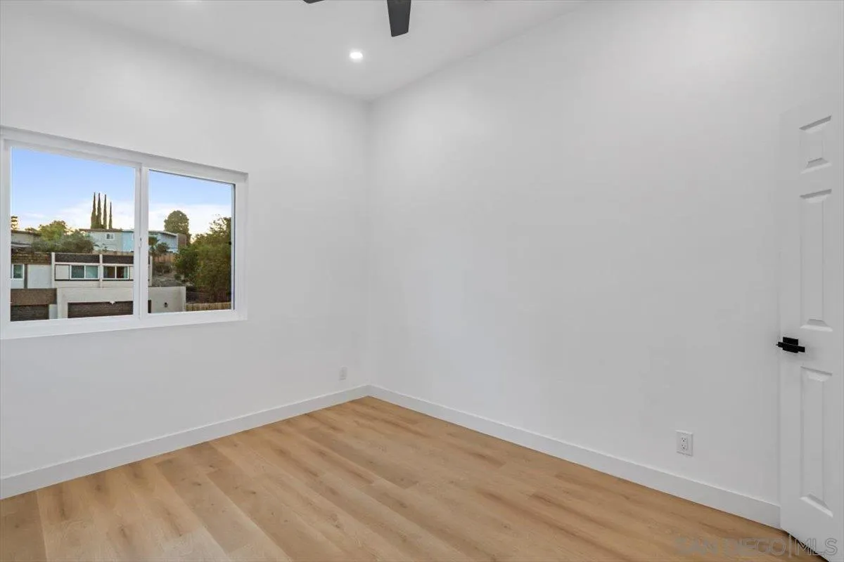 13259 Saddle Ridge Road Lakeside, CA 92040 - Photo 37 of 57 a view of an empty room with wooden floor and a window