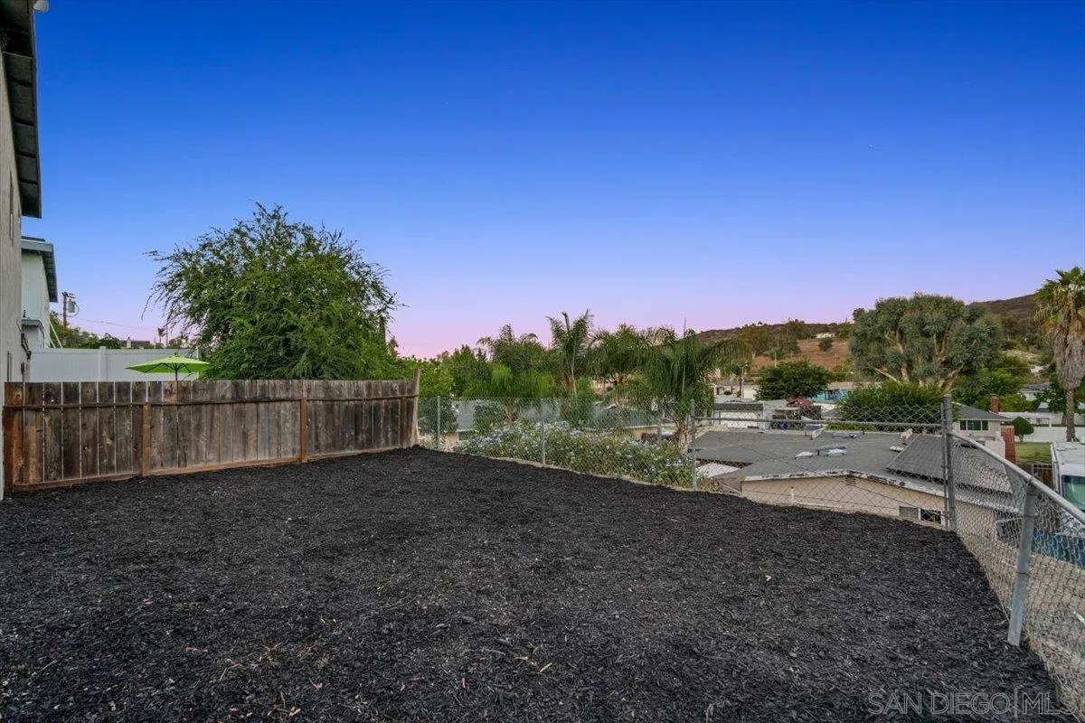 13259 Saddle Ridge Road Lakeside, CA 92040 - Photo 45 of 57 a view of a yard with a wooden fence